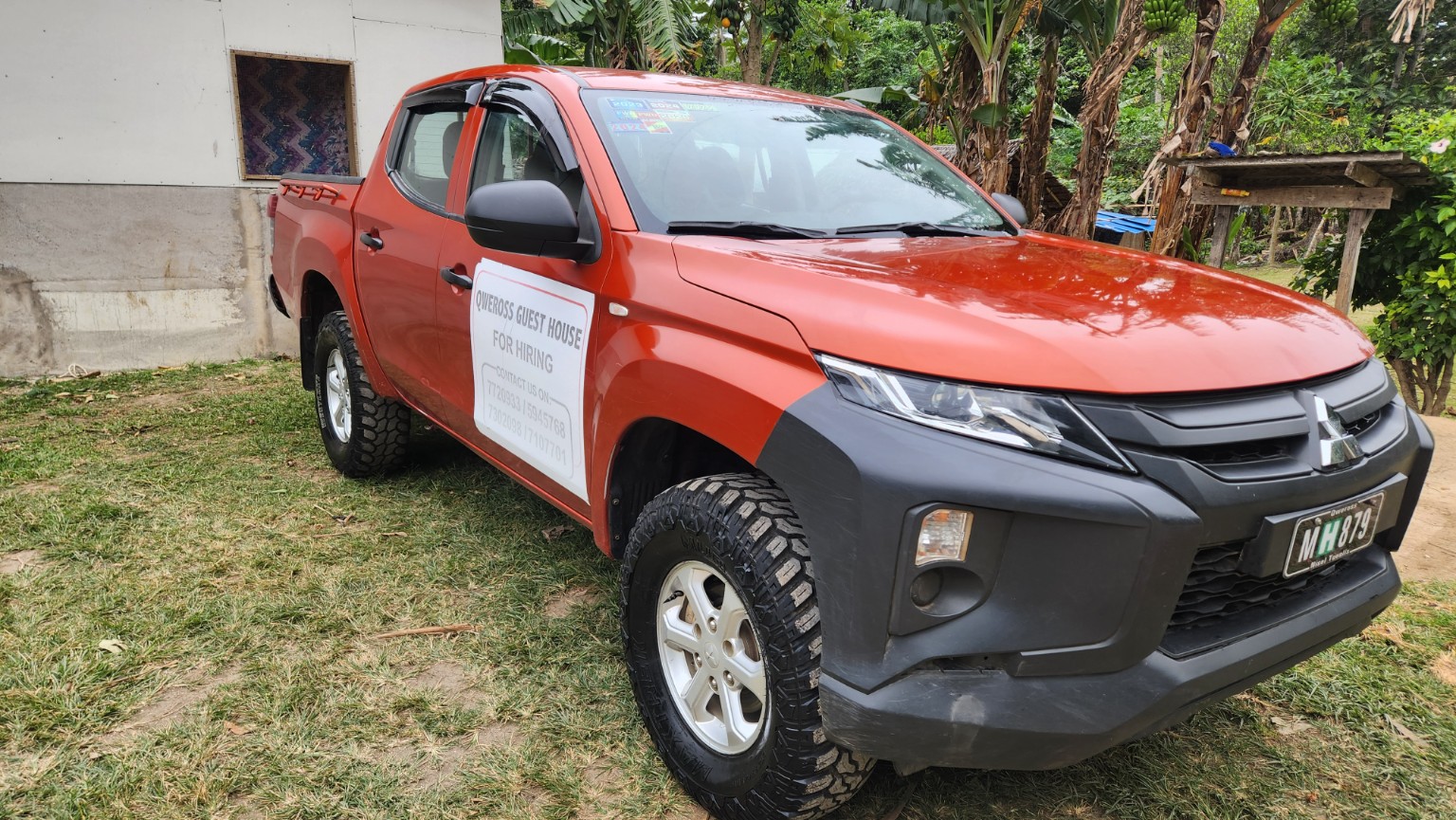 Red Mitsubishi double cab front three-quarter view