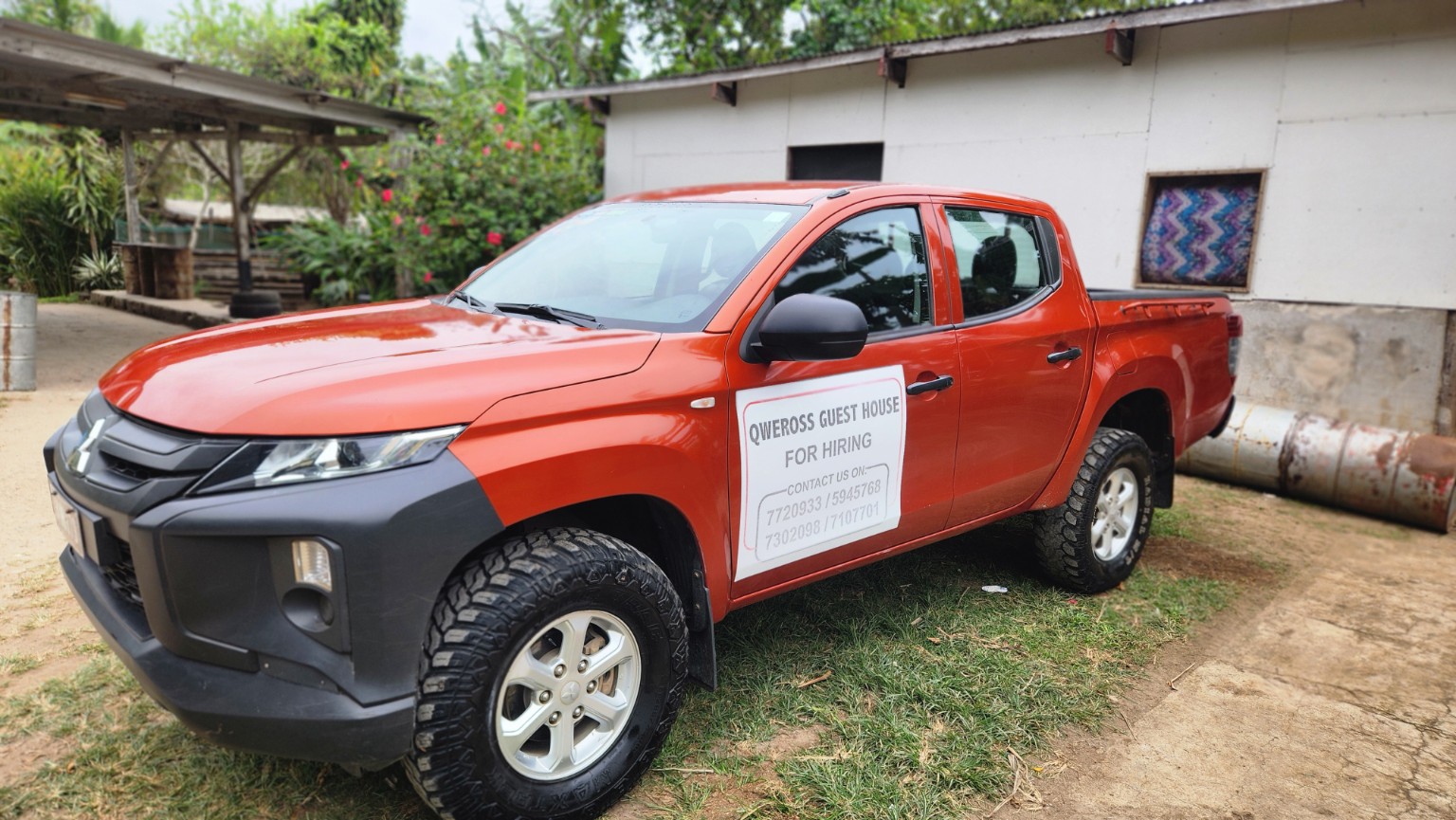 Red Mitsubishi double cab side view